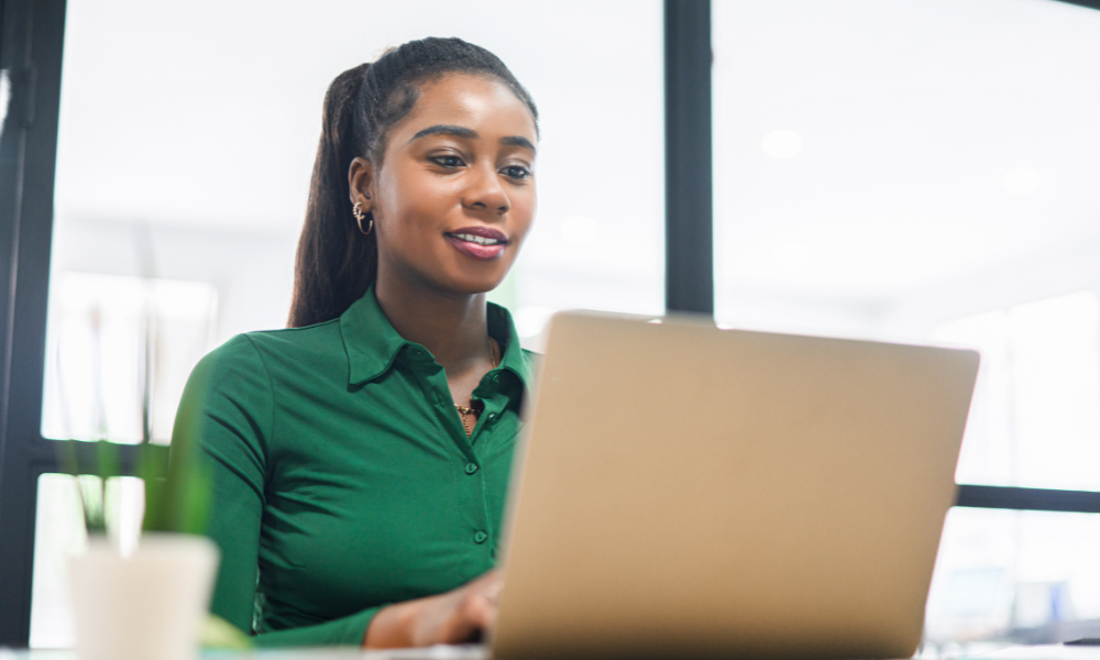 A female college student ah her employers office gaining valuable career exposure, hands-on skills, networking, conferences, fellowships, internships, pre-internships