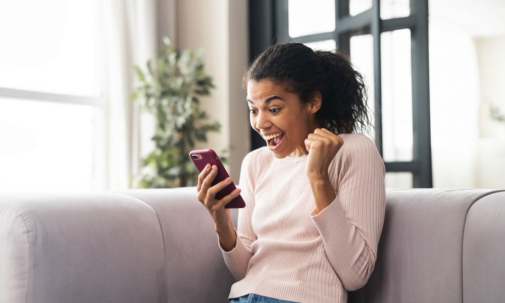 High school graduate is looking at her cell phone and is excited because she just won another scholarship for college, full-tuition, full-time student, high school junior, study abroad scholarships, public health, community organizations, grade point average, legal resident, eligibility