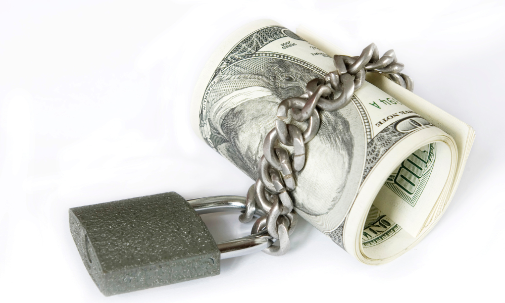 A roll of May Scholarship money chained with a lock, free application, eligibility requirements, international students, higher education, permanent residents, social justice, letter of recommendation, interested students, alumni scholarships, academic excellence, 500-word essay, advanced certificate, cost of tuition, us citizens, current undergraduate students, further ado, free money, financial assistance