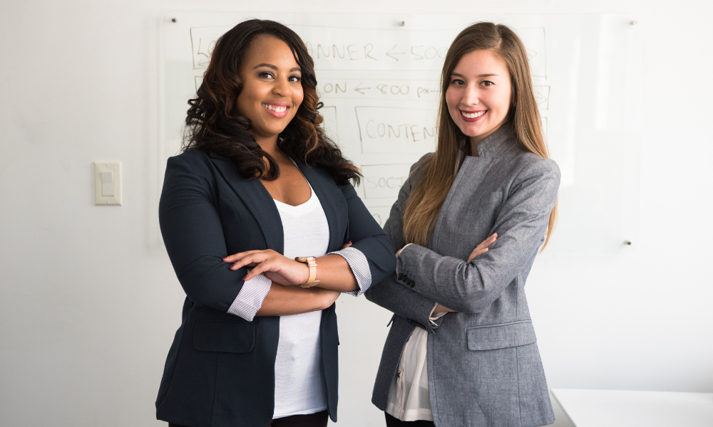 Two college females professionally dressed at their externship program