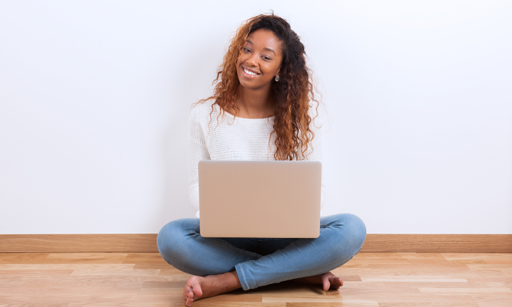 An incoming freshman is sitting with her laptop and applying for need-based scholarships, letters of recommendations, career path, uncf member institution, TMCF member institution, application process, african american women, significant contribution,first-generation students, Scholarships to Apply for by Late May