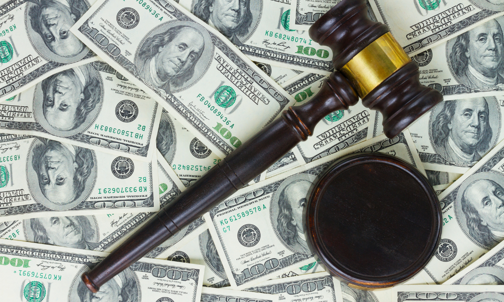 A judge gavel on top of a bed of law school scholarship money, merit scholarship awards, incoming diverse law students, private student loans, financial burden, federal loans, family member, minority law student scholarship program, caregiver scholarship, essay competition scholarships, law degree scholarship offers, public sector