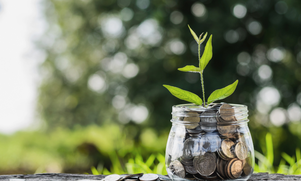 A glass jar filled with money that a high school student saved for college from a part-time job and from winning scholarships for law school