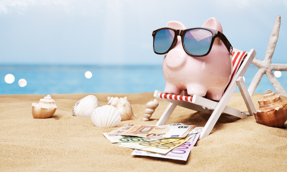 A piggy bank on the beach on top of scholarship money for Engineering majors, Nursing majors, Business majors, Marketing majors, Communication majors, STEM majors
