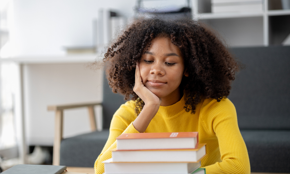 A high school senior is sitting in the library trying to find scholarships books so she can apply for scholarships with upcoming deadlines, scholarships for high schoolers, scholarships for high school freshmen, scholarships for high school sophomores, scholarships for high school juniors, scholarships due is September, scholarships for graduating seniors, scholarships with September Deadlines