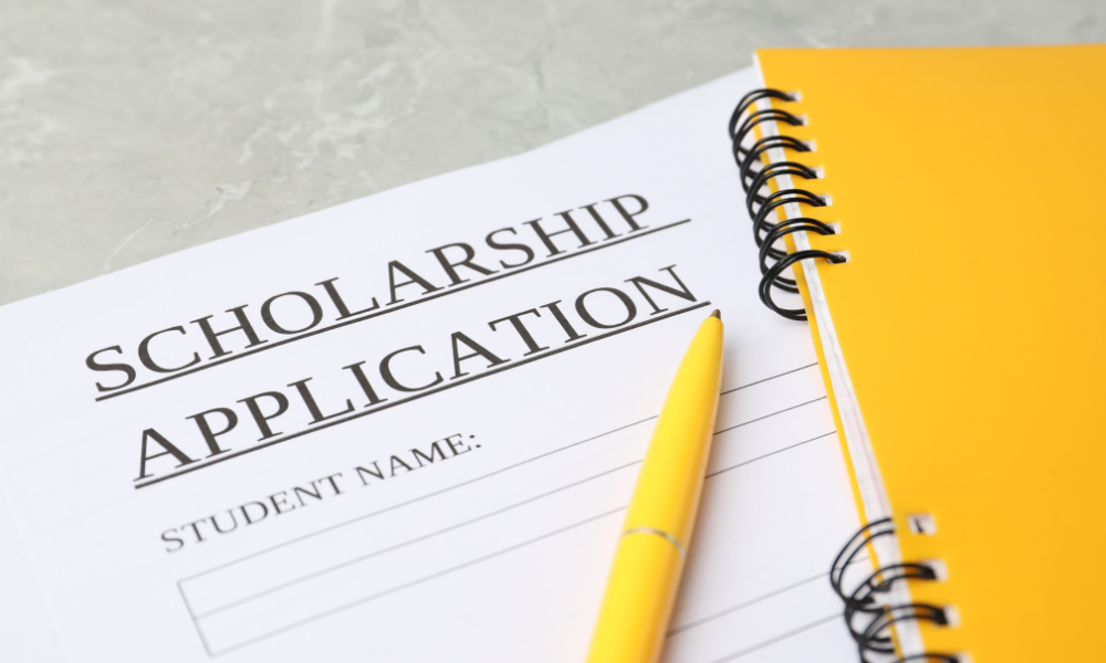 A yellow book with a scholarship application for scholarships due in November, financial need, financial aid, letters of recommendation, financial support, award letter, high school students, high school senior, college bound, college students, award amount, community service, November scholarship opportunities