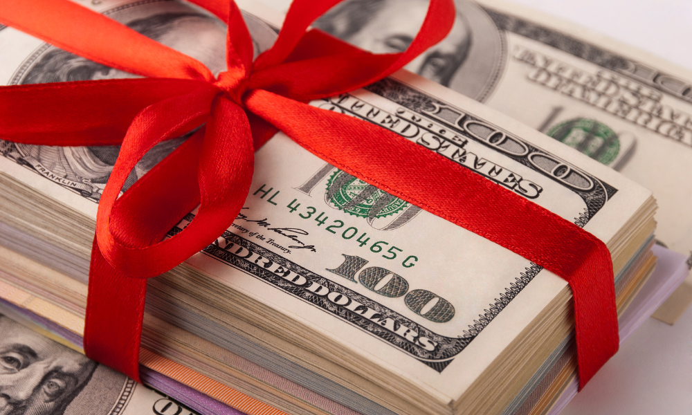 A stack of scholarship money wrapped in a red bow, business majors, STEM majors, tech majors, Business scholarships, STEM scholarships, Computer Science scholarships, Engineering Scholarships, Teacher Scholarships, Law scholarships, Nursing student scholarships, medical scholarships, medical school scholarships, grad scholarships, graduate school scholarships