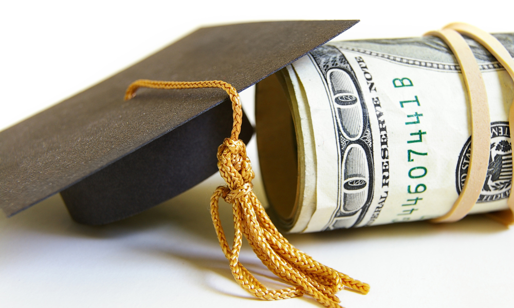 Grad hat sitting on top of a wad of scholarships money, scholarships due in January, scholarships with January deadlines, winter scholarships, scholarships for DC students, scholarships for California students, scholarships for Georgia students, Art scholarships, Accounting scholarships, Business major scholarships, healthcare scholarships, law school scholarships, communication scholarships