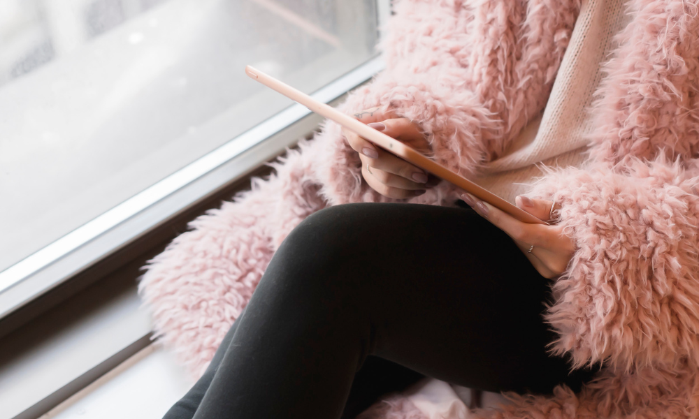 A female high school student sitting in her bedroom window looking for community foundation scholarships for students on her tablet. Most community foundations have one application which gives students access to several scholarships which may be based on community service, academics, and leadership skills