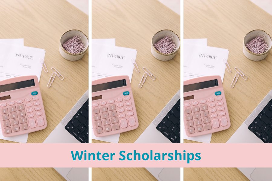 A college student has her calculator, laptop, and monthly expenses on her desk. She is calculating her tuition bill for her sophomore year of college. She is also applying for winter scholarships to help reduce her student debt.