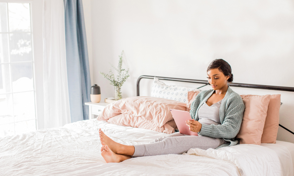 A college female is sitting on her bed with her iPad Air searching for community foundation scholarships. These scholarship funds are for high school seniors, high school students, nontraditional students, and current college students. Some of these scholarships can be used at trade schools, community colleges, or a technical school.