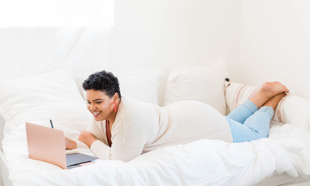 A college junior is laying on her couch looking for March scholarships for HBCU students and people of color. The student wants to apply for scholarships with minimum GPA requirements and for renewable scholarships 