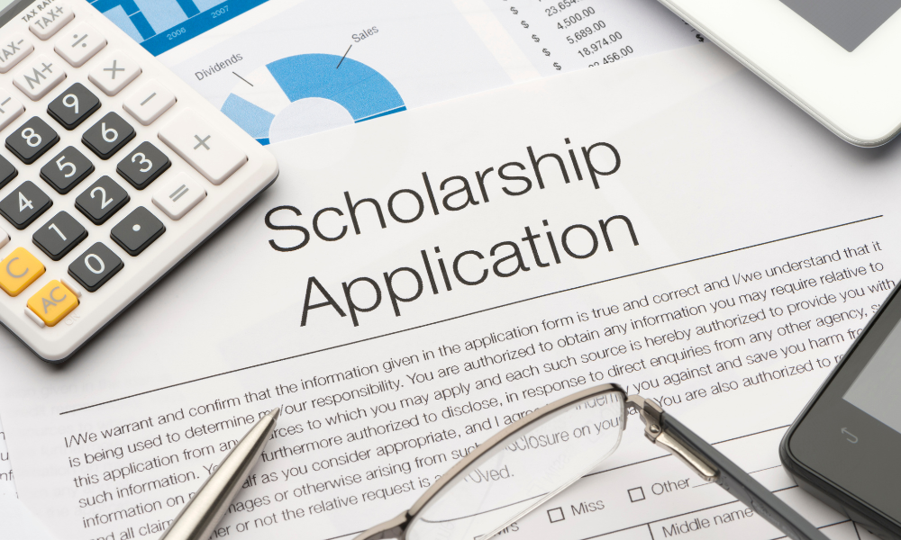 On top of the student's desk is a scholarship application for March scholarships for HBCU students, minorities, African American, Black, Hispanic, and Latino students