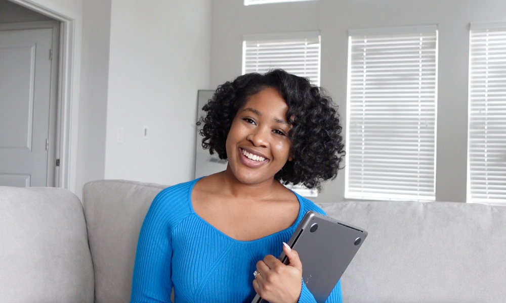 A current female law student is using her lap top to research scholarship opportunities and their eligibility requirements for law scholarships with spring deadlines