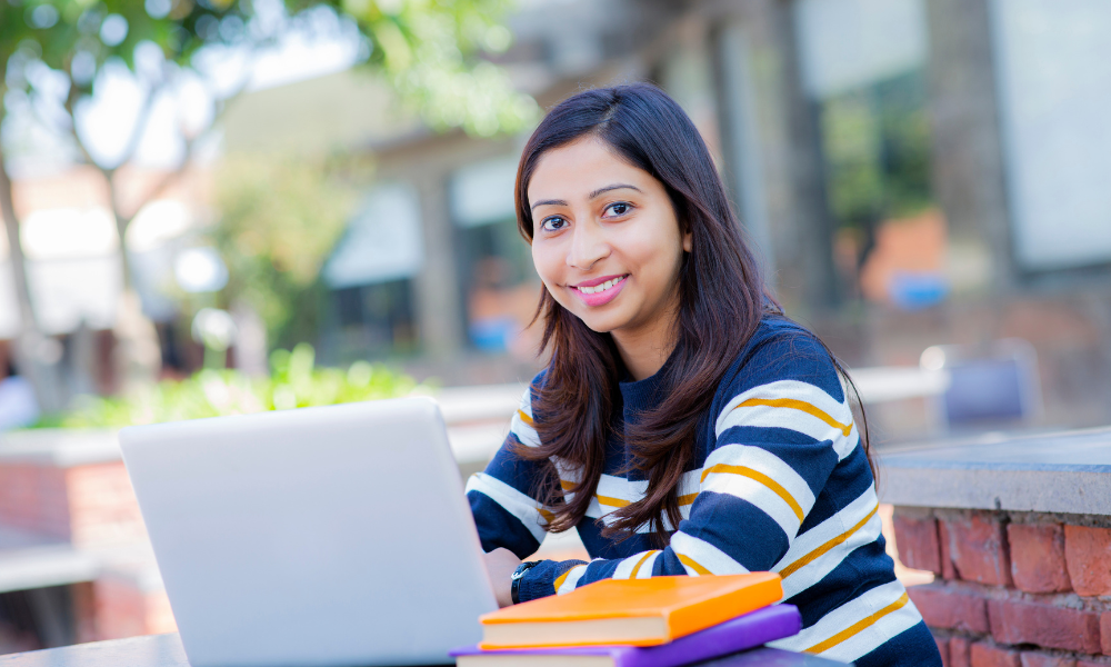 A college freshman is reading an email that was in her email spam and she found out she won a $10,000 scholarship for college. Her strategy to winning scholarships is only applying to the best fit scholarships, applying early, choosing the right recommenders, and following instructions exactly.