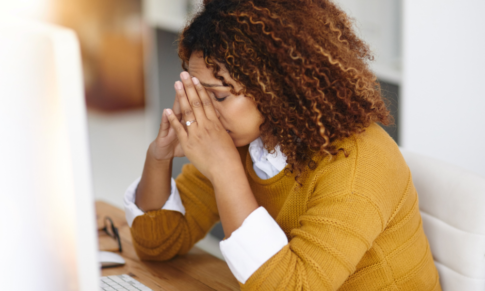 Female college student is sitting at her computer with disappointment because she missed a scholarship deadline, she has poor organizational skills, and she overlooked the eligibility requirements. She wants to make sure she avoids common scholarship mistakes.