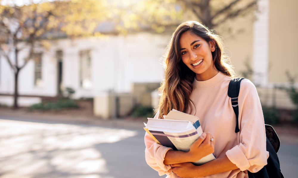 A graduate student is walking to her apartment after a long day of applying to May scholarships to help slash her law tuition.