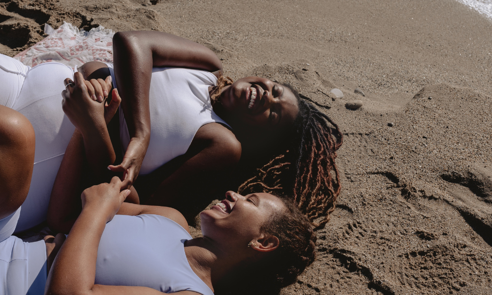 Two besties are hanging at the beach, after spending the morning applying to summer scholarships. They both has a summer scholarship list filled with easy and quick scholarships to complete over their summer break