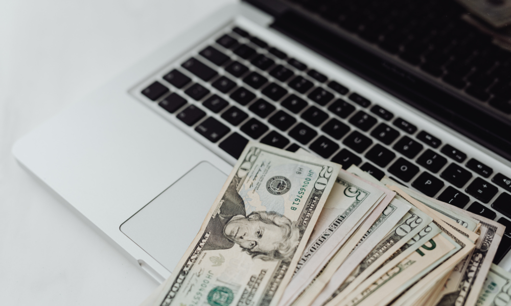 HBCU college senior is sitting at her laptop with her scholarships she won when she applied for scholarships for fall semester during her junior year, currently she is apply for business scholarships and MBA scholarships for her MBA program.