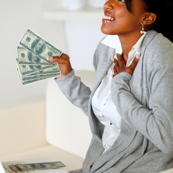 A college female is holding up dollars bills and smiling because she just won a minority scholarship, historically black college, HBCUs, african american women, computer science, african-american students, black women, eligibility requirements, minority groups, community service, eligible students, college degree, scholarship funds, college scholarships, great opportunity, native americans, scholarships with April deadlines