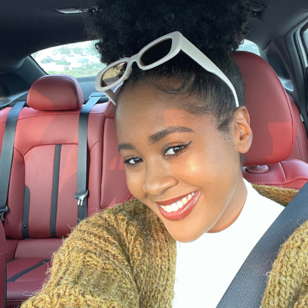 Twentysomething female sitting in her car smiling, best option, first time, best deal, credit score, kelley blue book, kind of car, good shape, car price, hard time, good idea, disposable income, used vehicle