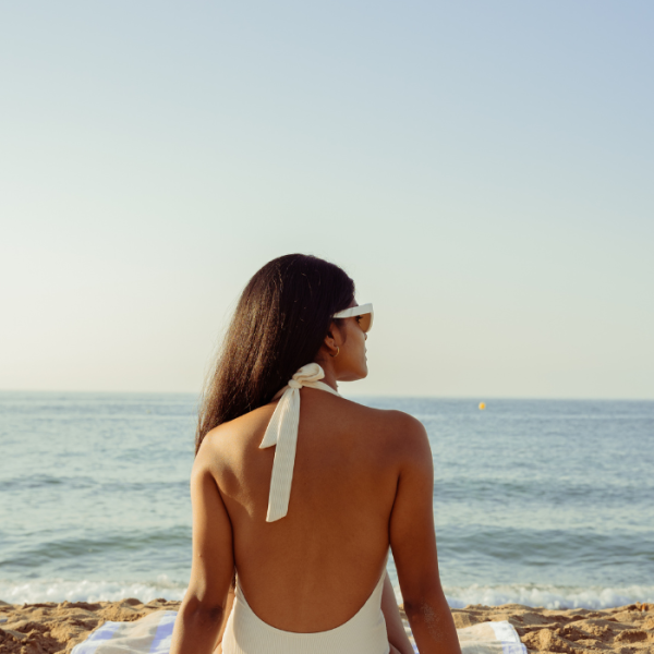 Graduate student sitting at the beach on her summer break, scholarships with July deadlines, summer break scholarships, July scholarships, minority student scholarships, scholarships for minorities